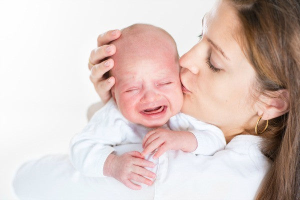 Crying baby being held by mother | Safe Sleep Space