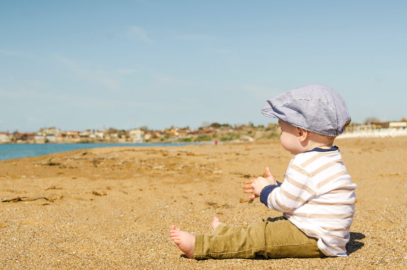 Babe sitting on beach | Safe Sleep Space