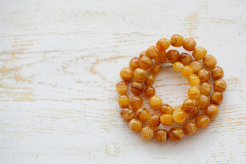 Coiled amber beads | Safe Sleep Space