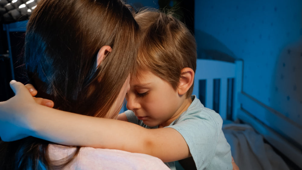 toddler hugging mother at bedtime
