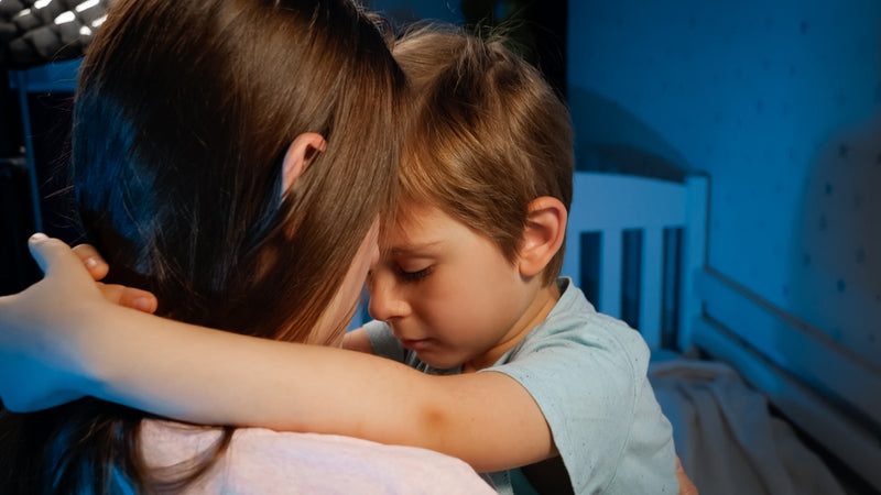 toddler hugging mother at bedtime