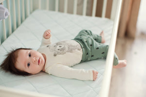 Help! My baby’s moving around the cot and getting their arm or leg stuck