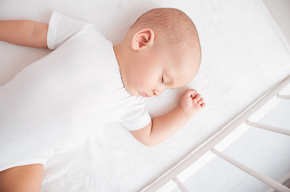 sleeping baby in cot