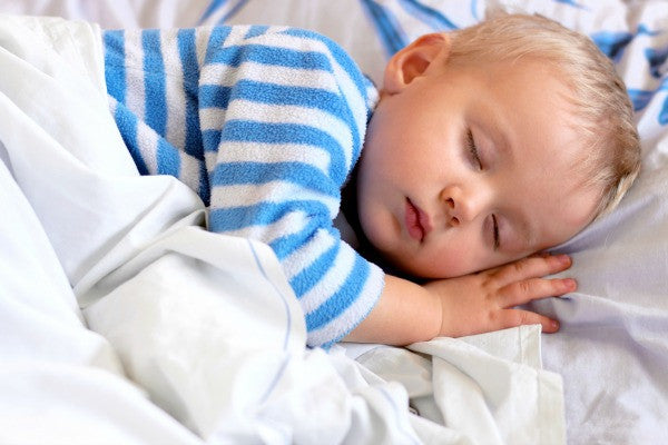 Toddler napping in a bed | Safe Sleep Space